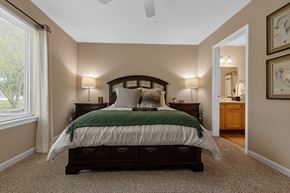 Fort Wayne apartment for rent - A bedroom with a large bed and a carpeted floor.