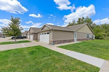 Fort Wayne apartment for rent - A house with a garage and a driveway in front.