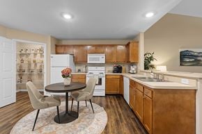 Fort Wayne apartment for rent - A kitchen with a table and chairs in the middle of the room.