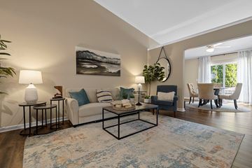 Fort Wayne apartment for rent - A living room with a white couch, a coffee table, and a painting on the wall.