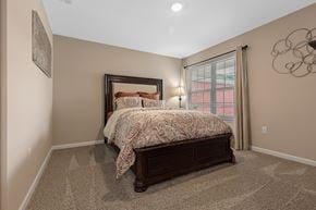 Fort Wayne apartment for rent - A bedroom with a large bed and a window with curtains.