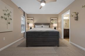 Fox River Grove apartment for rent - A bedroom with a large bed and a ceiling fan.