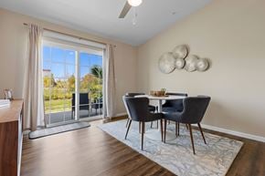 Grand Blanc Township apartment for rent - A dining room with a table set for two and a view of the outdoors.