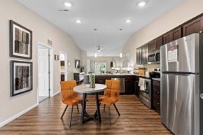 Grand Blanc Township apartment for rent - A kitchen with a table and chairs in the middle of the room.