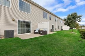 Grand Rapids apartment for rent - A building with a green lawn in front.