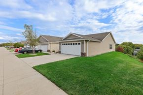 Grand Rapids apartment for rent - A house with a garage and a tree in front of it.