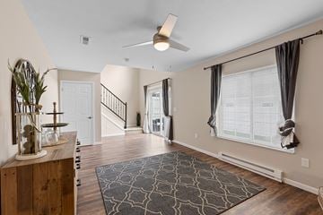 Grand Rapids apartment for rent - A living room with a rug on the floor and a plant on the table.