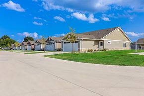 Greenfield apartment for rent - A row of houses with a clear blue sky above them.