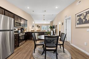 Greenfield apartment for rent - A kitchen with a table and chairs in the middle of the room.