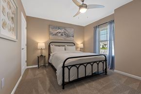 Greenfield apartment for rent - A bedroom with a large bed and a ceiling fan.