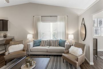 Greenwood apartment for rent - A living room with a grey couch and a coffee table.