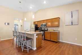 Greer apartment for rent - A kitchen with wooden cabinets and a white island.