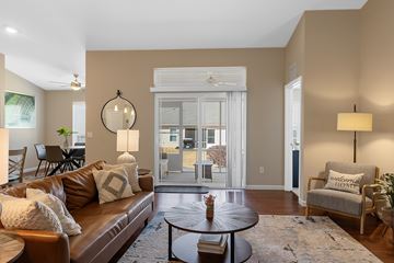 Greer apartment for rent - A living room with a brown leather couch and a round table in the center.