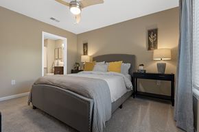 Greer apartment for rent - A bedroom with a large bed and a ceiling fan.