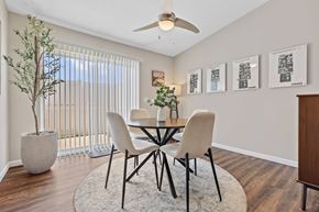 Grove City apartment for rent - A dining room with a table, chairs, and a plant.