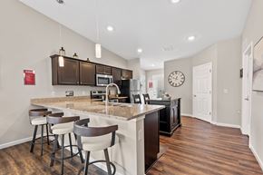 Grove City apartment for rent - A kitchen with a bar area and a clock on the wall.