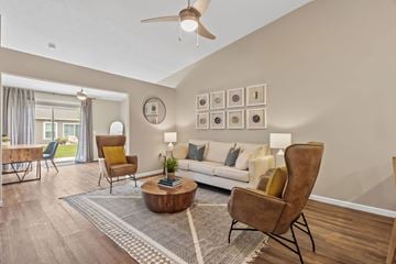 Groveport apartment for rent - A living room with a brown chair and a white couch.