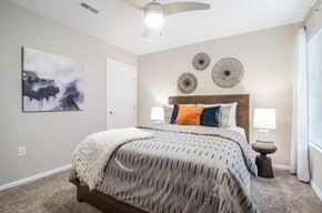 Groveport apartment for rent - A bedroom with a large bed and a ceiling fan.