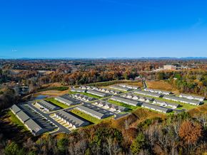 Hickory apartment for rent - A bird's eye view of a residential area with houses surrounded by trees.
