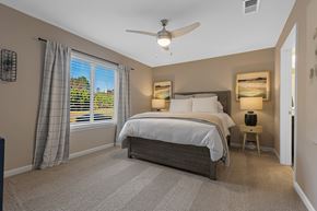 Hickory apartment for rent - A bedroom with a large bed and a ceiling fan.
