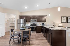 Holt apartment for rent - A kitchen with brown cabinets and a white refrigerator.