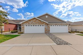 Howell apartment for rent - A house with a red garage door and a stone border on the driveway.