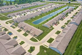 Indianapolis apartment for rent - A bird's eye view of a residential neighborhood with houses and a swimming pool.