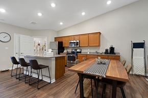 Indianapolis apartment for rent - A kitchen with a table and chairs in the middle of the room.