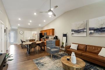 Indianapolis apartment for rent - A living room with a brown leather couch and a wooden coffee table.