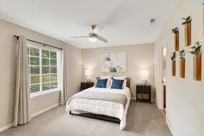 Indianapolis apartment for rent - A bedroom with a large bed and a ceiling fan.