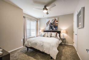 Johnstown apartment for rent - A bedroom with a large bed and a ceiling fan.