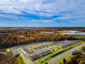 Kannapolis apartment for rent - A large parking lot with multiple rows of cars and a building in the background.