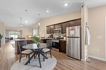 Kannapolis apartment for rent - A modern kitchen with a table and chairs in the middle of the room.