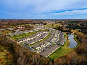 Kannapolis apartment for rent - A bird's eye view of a residential area with houses and a lake.