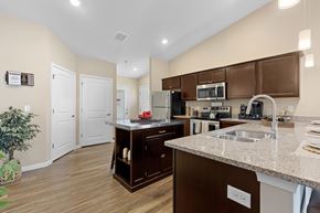 Lake Wylie apartment for rent - A kitchen with brown cabinets and a white countertop.