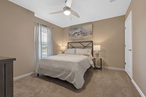 Lake Wylie apartment for rent - A bedroom with a large bed and a ceiling fan.