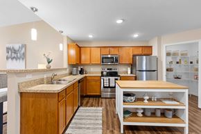 Lebanon apartment for rent - A kitchen with wooden cabinets and a stainless steel refrigerator.