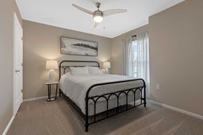 Lebanon apartment for rent - A bedroom with a bed, nightstand, and a ceiling fan.