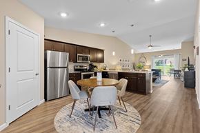 Lockport apartment for rent - A modern kitchen with a dining table and chairs in the middle.