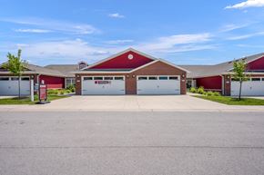 Louisville apartment for rent - A red building with a white garage door in front.