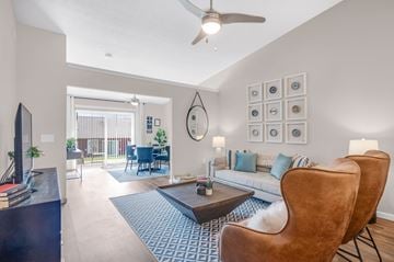 Louisville apartment for rent - A living room with a brown leather chair and a blue patterned rug.
