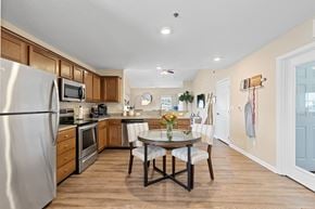 Macomb apartment for rent - A kitchen with a table and chairs in the middle of the room.