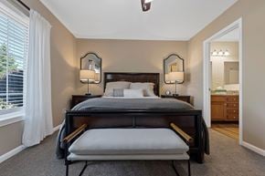 Macomb apartment for rent - A bedroom with a large bed and two lamps on either side of the bed.
