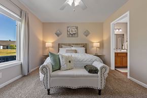 Marysville apartment for rent - A bedroom with a bed, two lamps, and a ceiling fan.