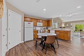 Marysville apartment for rent - A kitchen with brown cabinets and a white fridge.