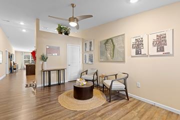 Mauldin apartment for rent - A living room with a brown rug and a ceiling fan.