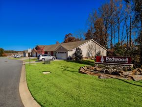 Mauldin apartment for rent - A sign that says Redwood is in front of a grassy area.