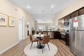 Merrillville apartment for rent - A modern kitchen with a dining table and chairs in the middle.
