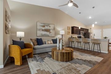 Merrillville apartment for rent - A living room with a yellow chair and a grey couch.