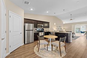 Miami Township apartment for rent - A modern kitchen with a dining table set for two.